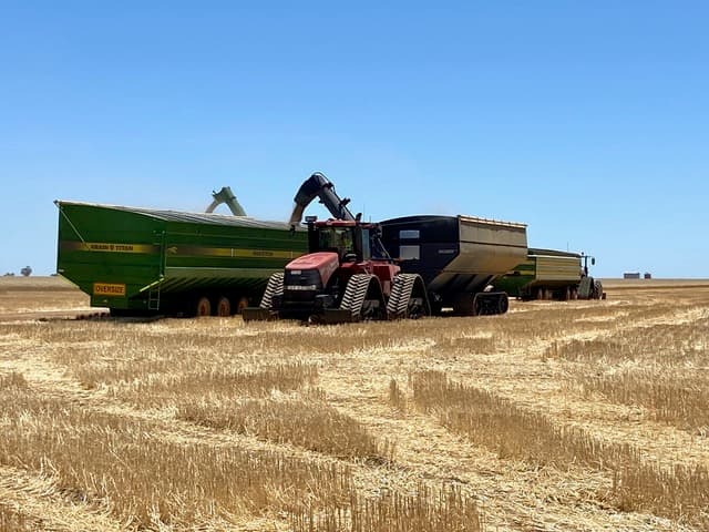 Tractor and grain carts working in the field